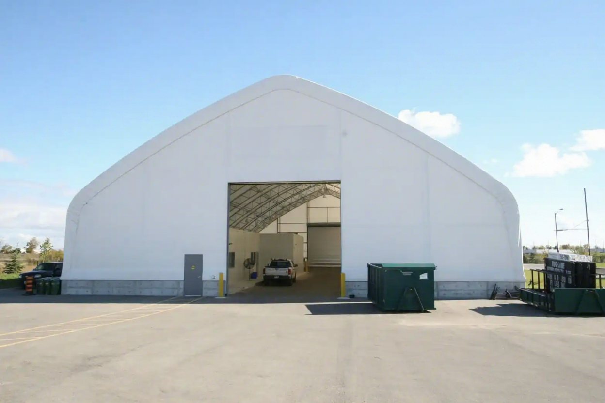 Large white fabric building with truck access