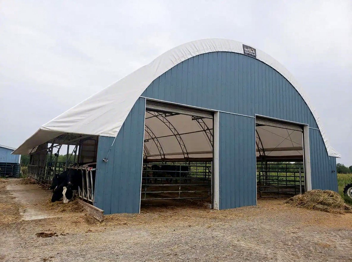 Blue livestock barn with fabric roof