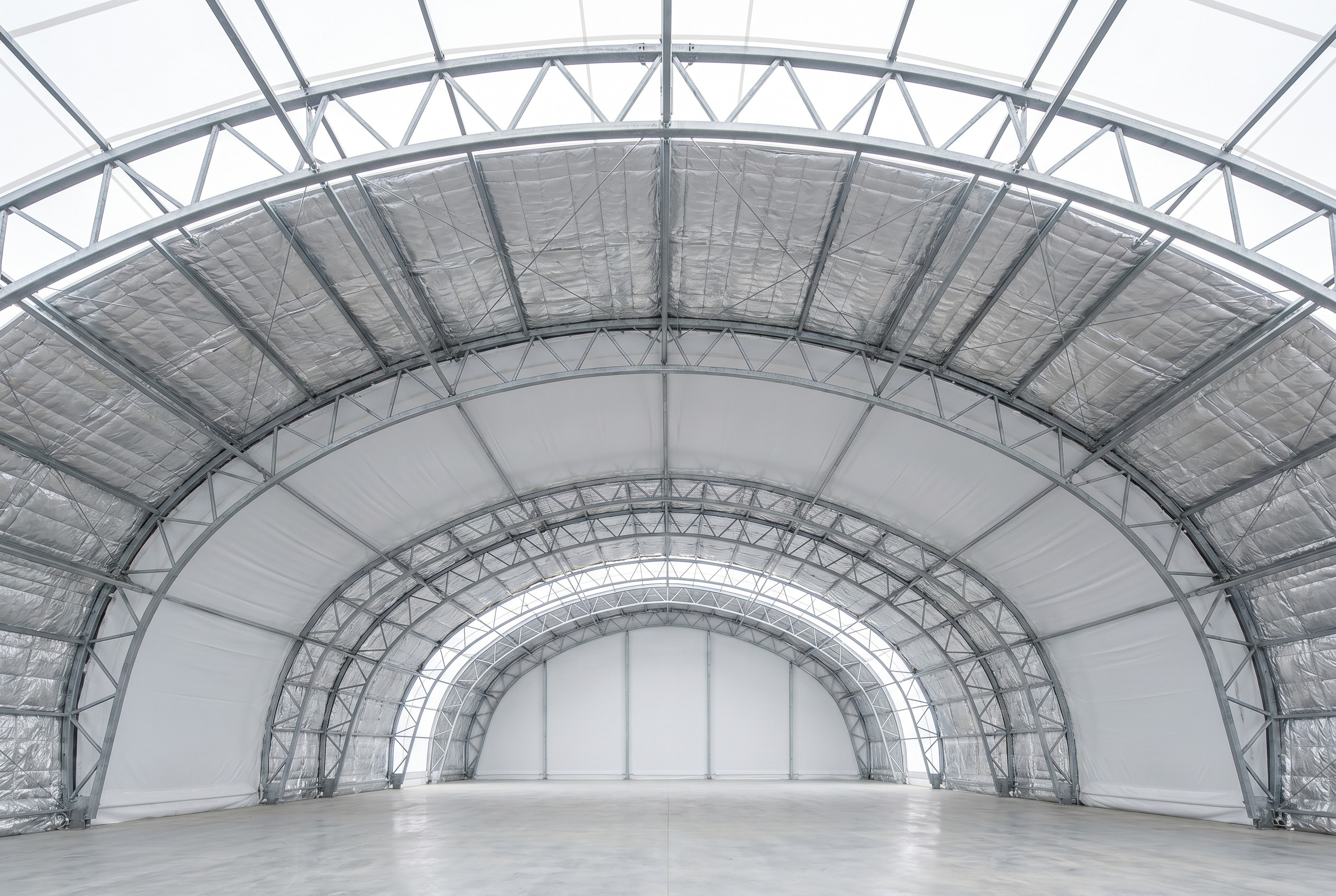 Insulated fabric building interior with thermal liner